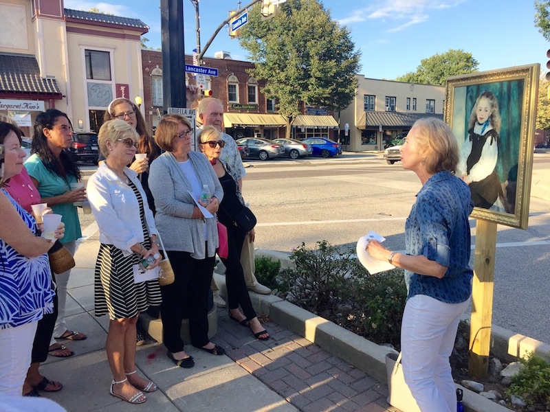 PMA guide and former Radnor H.S. art teacher Susan Wolf explains a Renoir at Lancaster and Louella Aves. during last week's kickoff art crawl. 