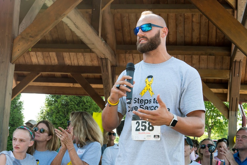 Pro football player Mark Herzlich addresses hundreds of fellow sarcoma survivors and their families at the second annual Steps for Sarcoma walk/run in Chesterbrook. 