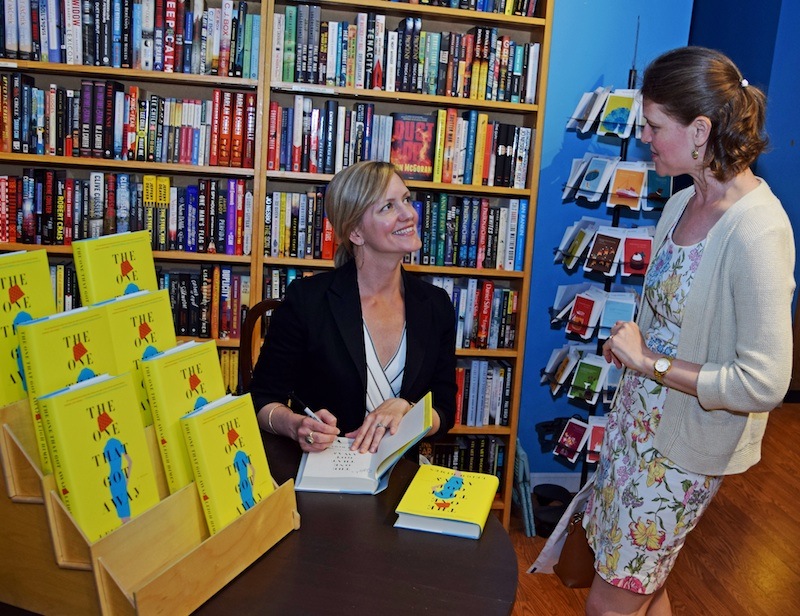 Author Leigh Himes signs a book for Rebecca Timme at Main Point Books. 