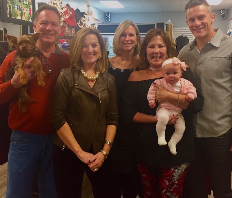 Polka Dots' co-owners Jim McCloskey (with store mascot, Gracie) and Ryan Randels (right), celebrate Susan Randel's enduring Polka Dots legacy with Susan's granddaughter McKenna and store managers Karen Denney, Lori Horning and Sheila Wagner. 