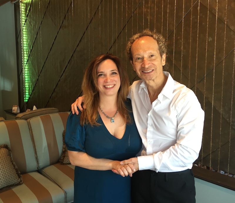 Essent Spa owner Dr. Alison Albiri and salon owner Jay Michael in front of the titanium waterwall in the new spa’s tranquility room. 